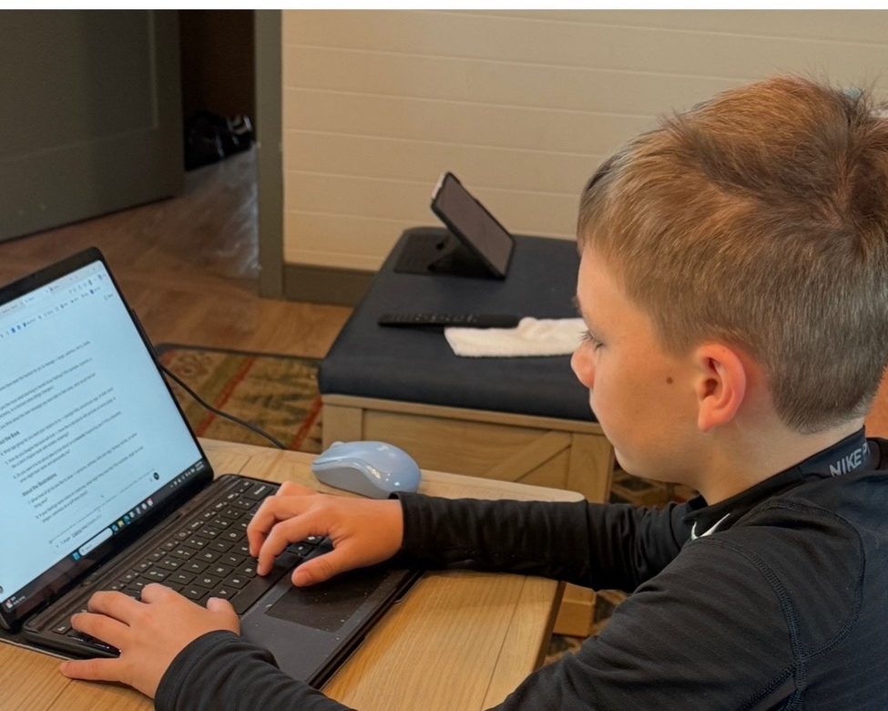 Seth writing his book on a laptop